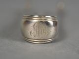 a close up of a silver ring with a monogram on it