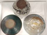 three bowls sitting on a tray on a table