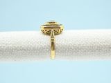 a close up of a gold ring on a napkin