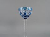 a blue and white wine glass sitting on a table