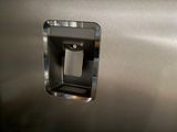 a close up of a stainless steel refrigerator with the door open