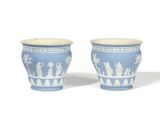 two blue and white vases with figures on them