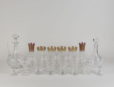 a lot of glasses and vases sitting on a table
