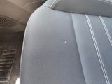 a close up of a car seat with a hole in it