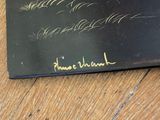 a black book with writing on it sitting on a wooden table