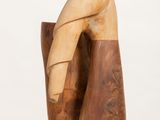 a wooden sculpture of a hand on a white pedestal