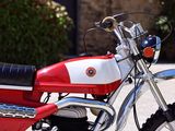 a red and white motorcycle parked on the side of the road