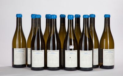 six bottles of wine are lined up in a row on a table