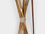 four canes and a cane holder on a white background