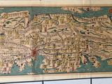 an old map of a city on a tile wall in a bathroom