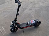 a scooter that is sitting on the ground in the parking lot