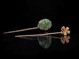 a pair of gold and jade flower hair pins