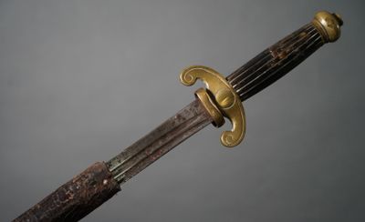 a close up of a sword with a wooden handle