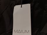 the back of a black jacket with a tag on it