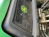 a close up view of a green tractor with a sticker on the front of it