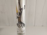 a vase with a drawing on it sitting on a table