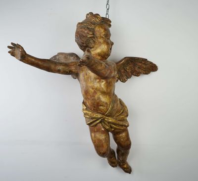 a small statue of an angel hanging from a chain