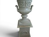 a white vase that is on a pedestal on a white background