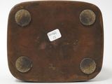 an image of a brown square shaped object with holes on it