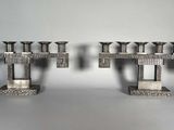deux bougies en métal posées sur une table
