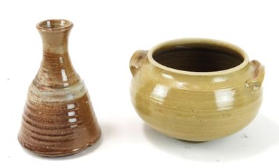two vases sitting next to each other on a white surface