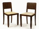 two wooden chairs with beige upholstered seats on a white background