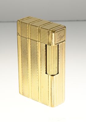 a gold lighter that is sitting on a table