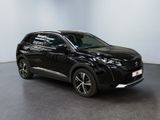 the black suv is parked in a room with a white wall