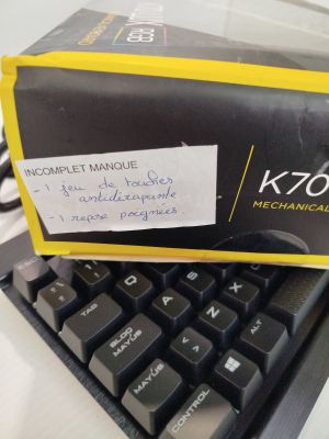 a box on top of a keyboard with a sticker on it