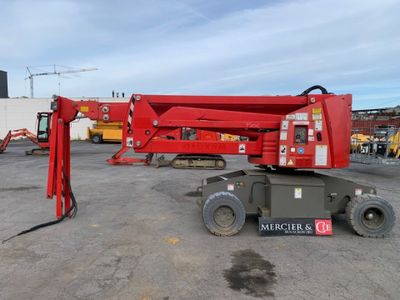 a red crane that is parked in a parking lot