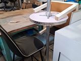 a table with a chair and a table with a lamp on it