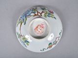 a white plate with a bird on it on a table