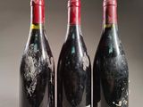 three bottles of wine are sitting next to each other on a table