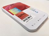 a white cell phone sitting on top of a white table