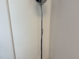 a lamp that is on the floor in the corner of a room