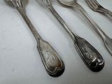 five spoons and two spoons sitting on a table