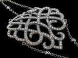 an image of a diamond necklace on a chain on a black background