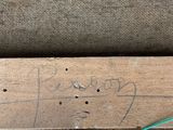 a piece of wood that has a green wire on it