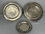 three silverplated dishes are sitting on a white surface
