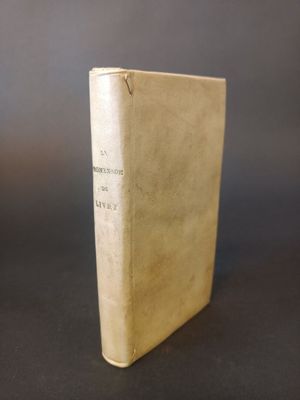 an old book sitting on top of a table with a black background