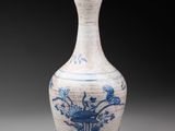 an old blue and white vase with flowers and birds on it