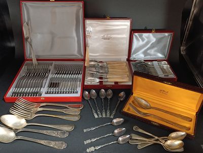 a lot of silverware in a red case on a table