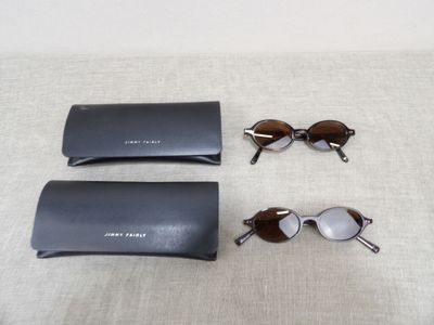 two pairs of sunglasses and a pair of glasses on a table