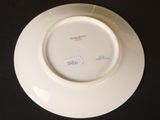 a white plate with a label on it on a black table