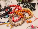 many different colored beads on the table together