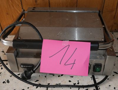 a toaster on the floor with a pink sticker on it