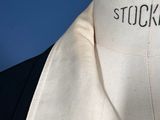 a white shirt with a black tie on a mannequin