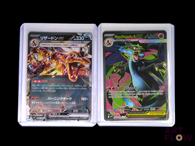 two pokemon cards are sitting side by side on a black background