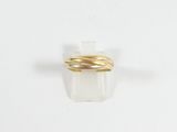 an image of a close up of a gold ring on a white surface