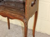 a small wooden table with a drawer on it